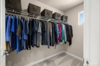 Attached walk in closet with a window for natural lighting.