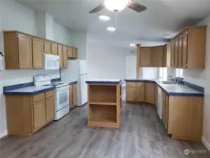 Very Spacious Chef Storage Prep Island Kitchen with Real Oak Wood Cabinets, Tile Back Splash, LED Lighting, New Paint, Trim, Ceiling Fan, Appliances, Including Built In Microwave and Vinyl Plank Flooring.