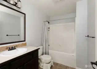 Full guest bathroom. Laundry room not pictured with washer & dryer and cabinets. All appliances are included.