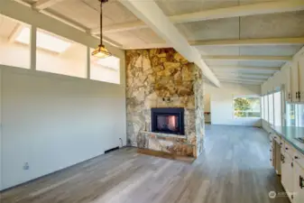 Floor to ceiling stone wall with gas fireplace.