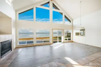 Walls of windows to enjoy this million dollar view! Great open space on the waterfront side of the home for living and dining room. Cozy fireplace to enjoy a relaxing day or evening. The sliding glass door is brand new.