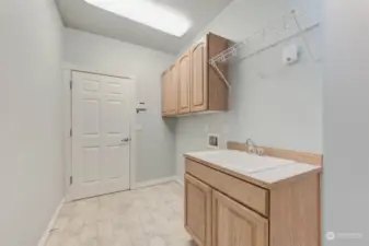 Laundry/Mud Room off of garage with sink and plenty of cabinet space.