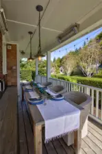 Entertain off the dining room with this cheerful alfresco space with built in bench and custom lighting.  Equipped with dual outdoor heaters, your dinner party can go well into a cool night.