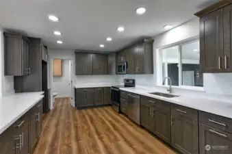 Large kitchen when you enter the home - all new cabinetry, appliances & quartz countertops