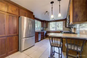 Cherry cabinets and granite tile counters. Stainless steel propane stove/range.
