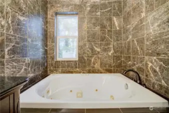 Jetted tub with marble surround to enjoy candle light bubble baths.