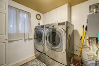 Laundry room with storage cupboards off kitchen.
