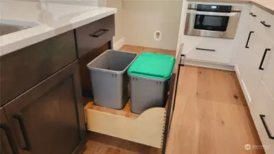Handy pull out for trash & recycling . an under-counter microwave drawer for convenience.