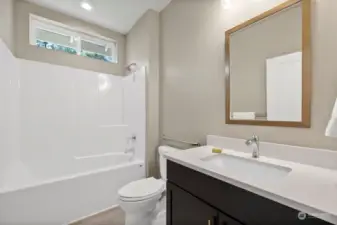 Coordinated lighting & mirror in guest bath. Comfort-height Kohler toilet in both baths.