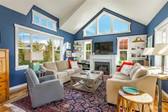 The living room is bright and cheery with the large windows.  Sellers added a gas fireplace to help make it inviting and cozy in the winter months. The main floor has beautiful acacia hardwood flooring.