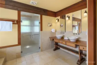 The primary bathroom is extensively finished in limestone, with heated floors and an extra large shower with two shower heads.