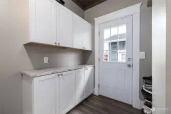 Mudroom and laundry area with built-ins