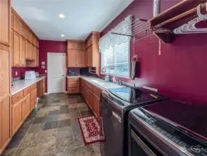 You will love this mud room, laundry room with lots of cabinets and counters. Also large windows for lots of lights. The door at the end of the shot is a mechanical room that includes the CAD wiring, furnace and tankless water heater.