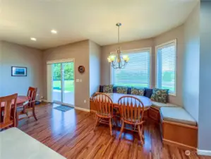 This shot also shows the formal dining room and the informal breakfast nook with bench seating with storage under seating. There is also easy access to the front pation through the sliding glass doors.