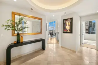 Entry has great presence. Welcoming you with a dramatic ceiling feature and art walls, there is also access to the guest bedrooms and the powder room.