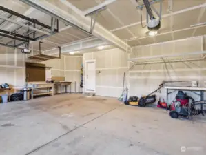 Huge 3-car garage with work bench and upper storage