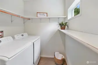 Check out this amazing laundry room! Plenty of shelving, a sweet window, and yes, all appliances stay! There's even a fridge/freezer on the other side of this room (behind the photographer) that stays too!