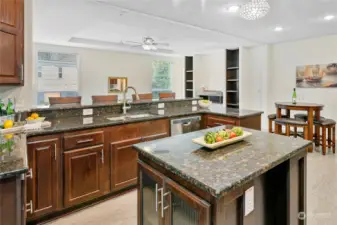 Just wow. This enormous kitchen has it all! Gorgeous cabinetry, a large island with gorgeous reeded glass on both ends, striking granite countertops... this kitchen is a showstopper for sure!