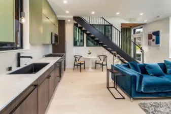 The floating staircase not only serves as a stunning focal point with solid, hard maple treads, but also efficiently connects the living spaces without compromising on style.