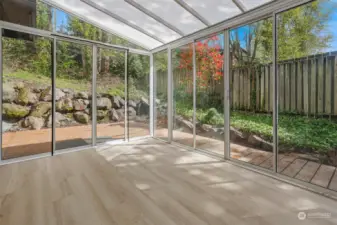 Sun room off the dining room with doors to back deck.