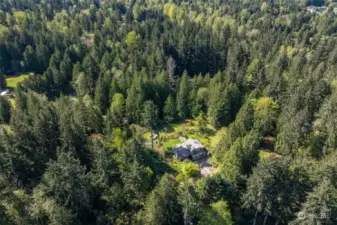 Home is nestled directly in the center of this shy 5 acre parcel for ultimate privacy.