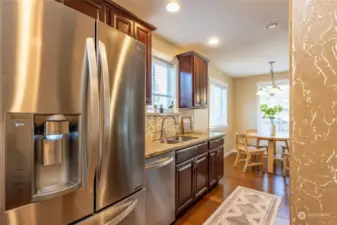 The kitchen has quartz counter tops and stainless appliances.
