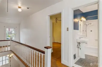 Upstairs hallway with full bath and original laundry shoot.