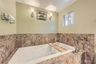 RELAXING JETTED TUB WITH CUSTOM TILE WORK.