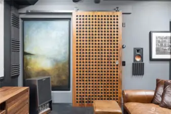Custom acoustic wall – both functional and beautiful – separates the media room / den from the other living spaces.