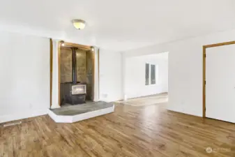 Family Room with Warm Glowing Wood Stove Great for Energy Saving and Cozy Winter Nights!