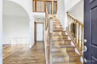 The grand dual wood staircase greets you as you enter.