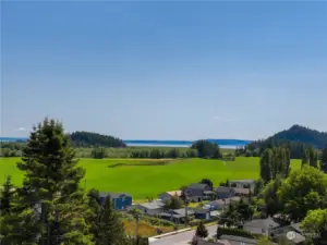 Step out onto the expansive deck, outstretched to the edge of the wall of granite below. Breathe deeply of the refreshing breezes and take in this masterpiece of picturesque farmland and Salish Seas beyond. You deserve it!