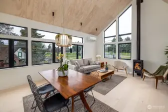 The living area serves as a comfortable retreat that overlooks Reservoir Park. The double height ceiling and modern fireplace create a warm, inviting atmosphere.