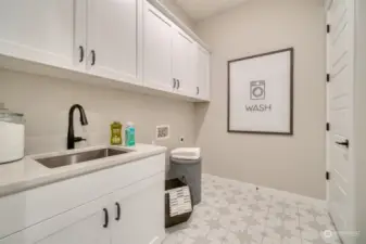 Large utility room with sink and cabinets.