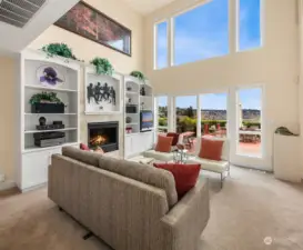 Double height ceilings and windows in the great room bring the outdoor vistas into the home.