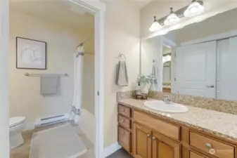 Extra vanity/sink area outside the bathroom allows for easy sharing of the space