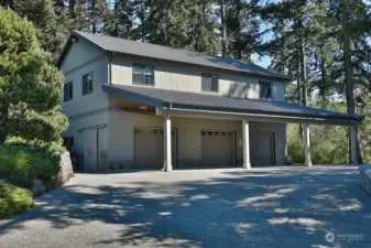 3-bay garage: 3,958 sq. ft., barn door entrance, wood burning stove, sink, 1/2 bath, 1st bay- manual chain hoist, plumbed for hot and cold water, 960 sq. ft. of covered parking stalls.