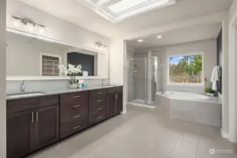 Featuring dual sinks, free-standing shower, soaking tub, and stone flooring