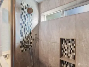 Gorgeous custom tiling throughout shower. Small window to let in natural light.