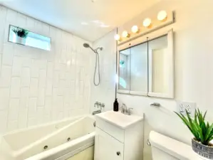 Bright, Freshly Painted, Remodeled Full Bath w/Jetted Tub & Shower, New: Tile, Vanity, Stainless faucet, & Flooring, on Main level next to Primary & Secondary Bedrooms & off of living room