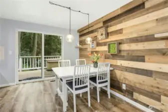 The spacious dining room has a stylish accent wall and is open to the back deck and kitchen.