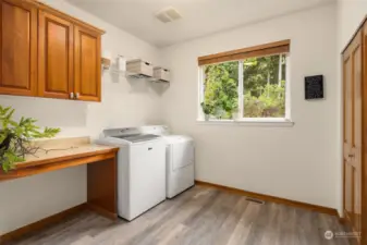 Spacious laundry room with storage and direct access to 5 car garage.