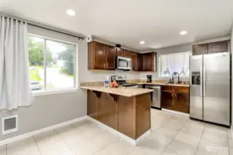The eat in kitchen features a peninsula and new Stainless Steel appliances.