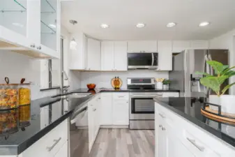 Spacious Kitchen with granite countertops and crisp white cabinets.