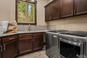 Laundry room with built in cabinets and granite countertops.