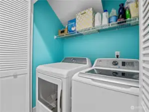 Laundry closet with shelving.