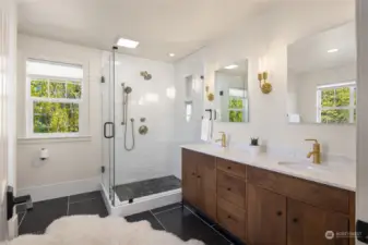 Luxurious ensuite bath features heated Belgian bluestone marble floors, walnut wood cabinet and double sinks, large glass enclosed shower...