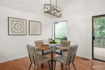 UPPER LEVEL EAT-IN KITCHEN AREA | This informal dining space enjoys the view of the backyard and generous deck.