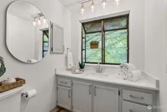PRIMARY SUITE BATHROOM | With a view to the backyard this bathroom is like a small sanctuary.