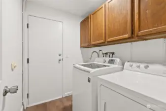 ENTRY LEVEL LAUNDRY ROOM | Through the door is the garage.